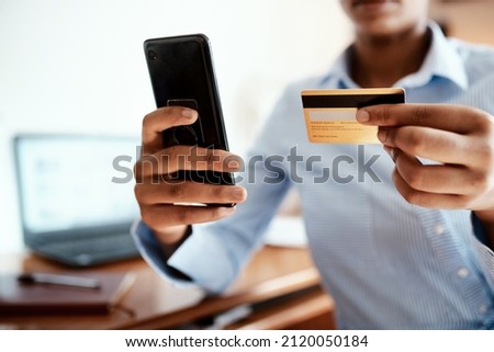 Keep things moving with the power of credit. Cropped shot of a businesswoman using a smartphone and credit card.