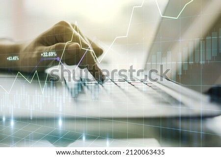 Multi exposure of abstract creative financial chart with hand typing on computer keyboard on background, research and analytics concept
