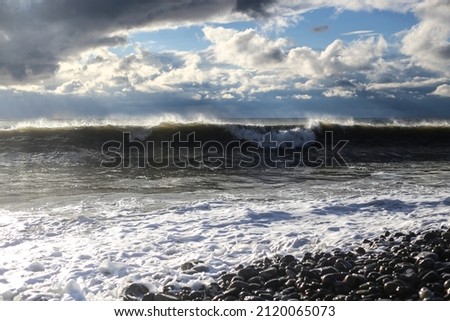 Storm waves on the Black Sea coast. Huge waves under gray skies. Stormy weather