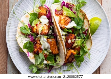 Tacos with salmon, pickled red cabbage, wasabi mayo and pea shoots