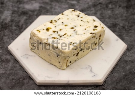 Cheese with herbs on a dark background. Minced goat feta cheese with herbs. Traditional Mediterranean cheese. Local name otlu peynir Royalty-Free Stock Photo #2120108108