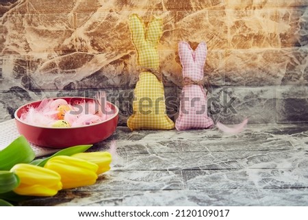 Easter background: carfting soft bunnies, yellow tulips. Copy space. Creative colorful spring. Easter background.