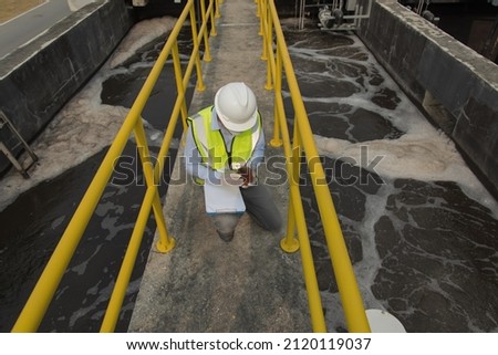 Wastewater treatment concept. Service engineer on  waste water Treatment plant. worker  working on Waste water plant. worker  working on Waste water plant. worker  working on Waste water plant. Royalty-Free Stock Photo #2120119037