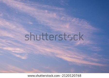 Blue sky with horizontal stripes of white cirrus clouds. Sky replacement texture.