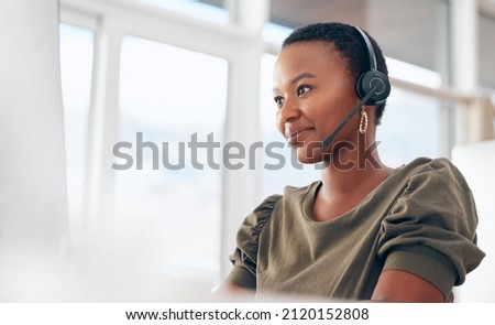 If you need us, call. Shot of a woman wearing a headset while working in a call centre. Royalty-Free Stock Photo #2120152808