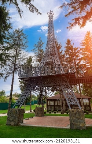 Reduced copy or stylized replica of the Eiffel Tower. Attracting tourists to the travel industry. Background with copy space for text