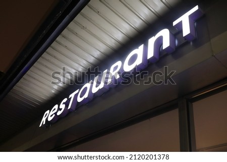View of restaurant sign board at night