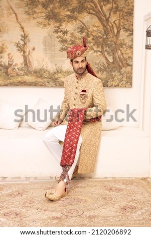 A male model is posing for the fashion shoot 