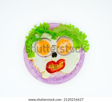 Fried eggs with vegetables in the form of funny cartoons, abstract, isolated on a white background