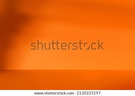 Empty orange room with deep artistic shadow. Minimalistic space concept Royalty-Free Stock Photo #2120223197