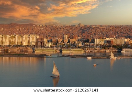 Panorama of Aswan city along Nile river with felucca boat in Egypt. Felucca is a traditional sailing boat used in the eastern Mediterranean - in Egypt and Sudan