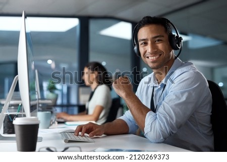 The customer is the real hero of this story. Portrait of a young man using a headset and computer in a modern office. Royalty-Free Stock Photo #2120269373