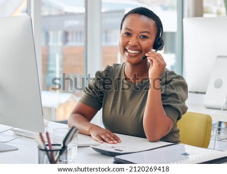 Im always happy to help. Shot of a woman wearing a headset while working in a call centre. Royalty-Free Stock Photo #2120269418