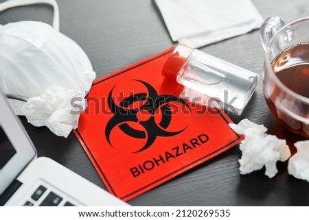 Lets stay home to protect ourselves and the people around us. Shot of a biohazard sign on a workstation.