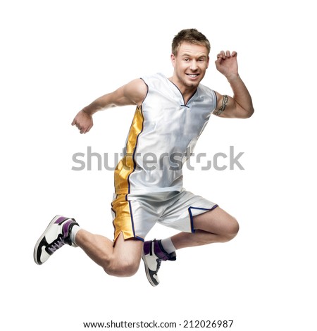 aggressive young basketball player jumping isolated on white