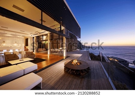 Fire pit on modern luxury home showcase beach house at sunset Royalty-Free Stock Photo #2120288852