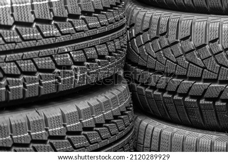 tread fragments of various new winter tires as a dark background Royalty-Free Stock Photo #2120289929