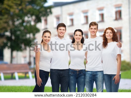 advertising, friendship, education, scool and people concept - group of smiling teenagers in white blank t-shirts over campus background