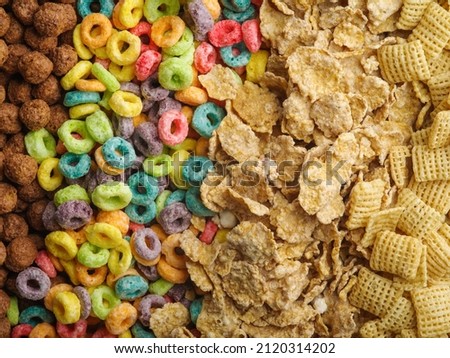 Quick whole grain breakfast cereals, pillows, fruit rings, chocolate balls. Assorted. Lots of different objects. macro photography. Healthy foods. Cooking, medicine, sports, baby food.
