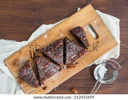 Pecan brownie cake on a wooden board
