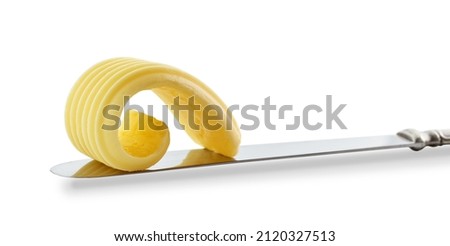 curl of fresh butter on a knife isolated on white background