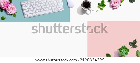 Computer keyboard and a mouse with pink roses - flat lay
