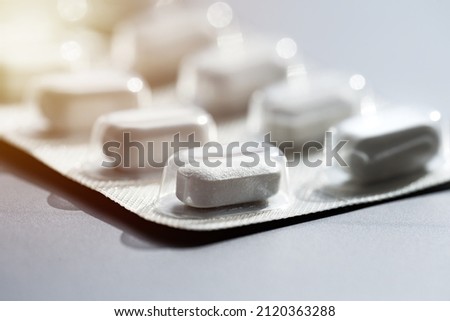 Closeup of pills in blister pack. Headache pills, painkillers, antibiotics or antidepressants tablets Royalty-Free Stock Photo #2120363288