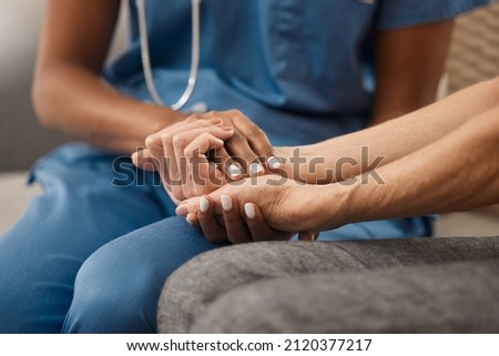Its okay if youre not feeling okay. Shot of a doctor holding hands with her patient during a consultation at home. Royalty-Free Stock Photo #2120377217