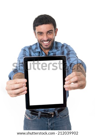 handsome man holding and showing blank digital tablet with copy space  in social network, internet blog and communication concept wearing casual clothes smiling happy isolated on white background 