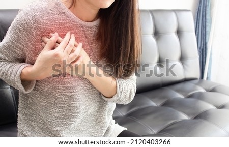 Asian beautiful Women touch chest heart attack symptom. Pain from heart stroke Healthcare and medical concept. Royalty-Free Stock Photo #2120403266