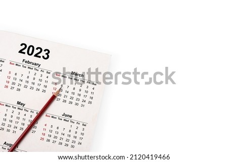 Calendar Year 2023 schedule with blank note for to do list on paper background. Flat lay with calendar, pencil on calander 2023. Close-up of a pencil on the page of calendar 2023. isolated on white