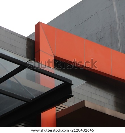 The building has a minimalist nuance, a combination of red and gray. Architecture photography.