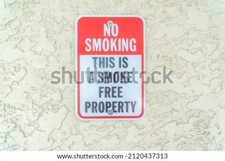 Close-up of a No smoking sign on a textured beige wall at Carlsbad, San Diego, California