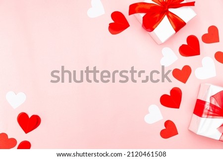 Valentine's Day. Gifts, hearts on rose background. Concept of love, affection. Holiday card.
