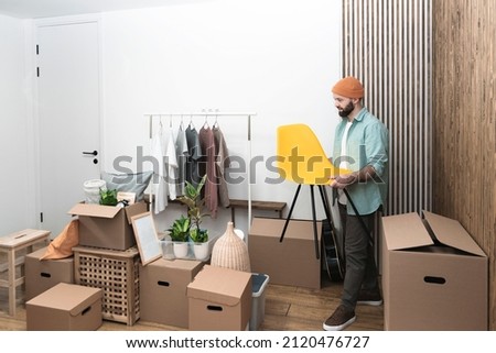 Adult men unpacking boxes in new home on moving day. High quality photo