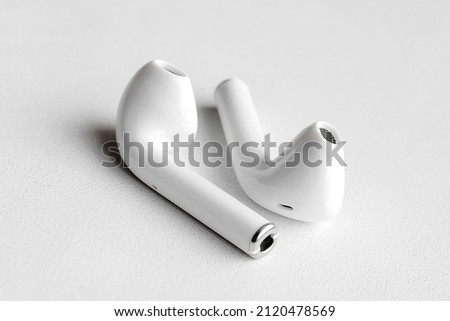 Wireless headphones on a white background, Close-up. The concept of modern technology.