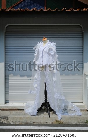 White wedding dress on a mannequin in the yard. Background, Copy space.