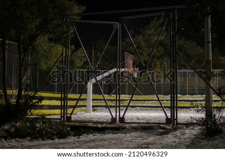 A snow-covered basketball court after a night winter blizzard