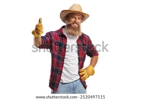 Young farmer with gloves and a straw hat showing thumbs up isolated on white background