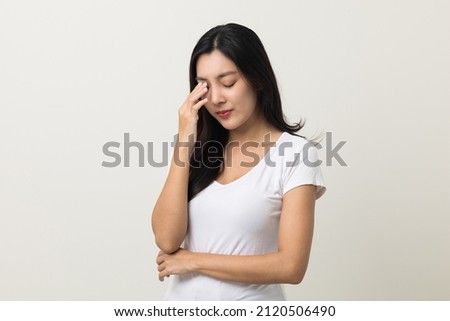 Young asian beautiful woman hand rubbing eyes she's feeling depressed stress headache be tired from working standing on isolated white background she has health problems. Royalty-Free Stock Photo #2120506490