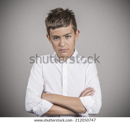 Closeup portrait skeptical young man, annoyed student in white shirt, looking with disbelief, camera gesture isolated grey wall background. Negative human emotion facial expression attitude perception