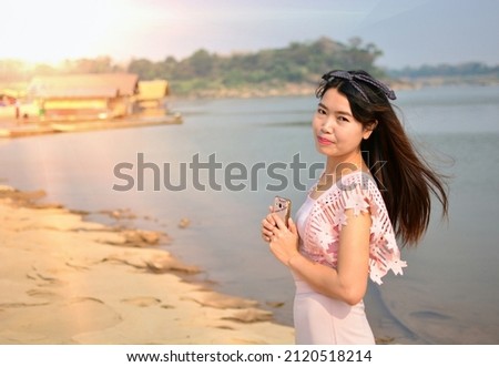 girl with a lollipop face by the river happy holiday travel, girl taking pictures by the river happiness travel travel