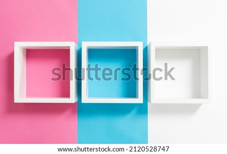Simply design with empty blue frame isolated on pink and blue pastel colorful background. Top view, flat lay, copy space, mock up. 