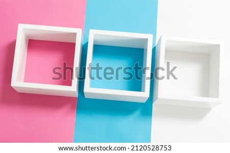 Simply design with empty blue frame isolated on pink and blue pastel colorful background. Top view, flat lay, copy space, mock up. 