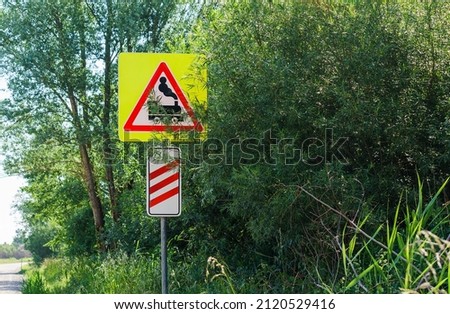 Warning sign before the railway crossing. The road sign of the railway crossing. Attention motorists.