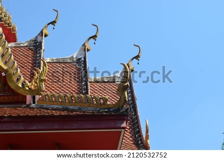 Gold gable apex the ornamental roof point with blue sky at Thailand temple