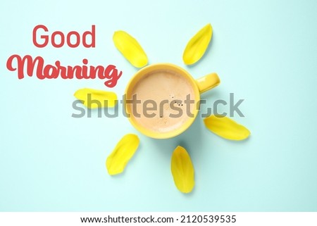 Good Morning. Cup of coffee and tulip petals on light blue background, flat lay