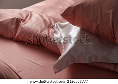 Closeup view of bed with beautiful silk linens Royalty-Free Stock Photo #2120558777