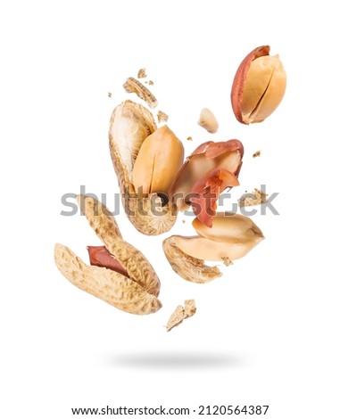 Crushed peanuts are flying in different directions in the air Royalty-Free Stock Photo #2120564387