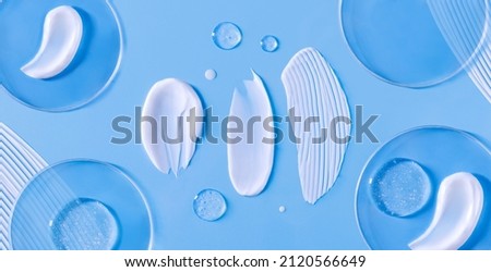 banner smear of cream round transparent drop of banner transparent gel serum in a petri dish on a blue background	
 Royalty-Free Stock Photo #2120566649